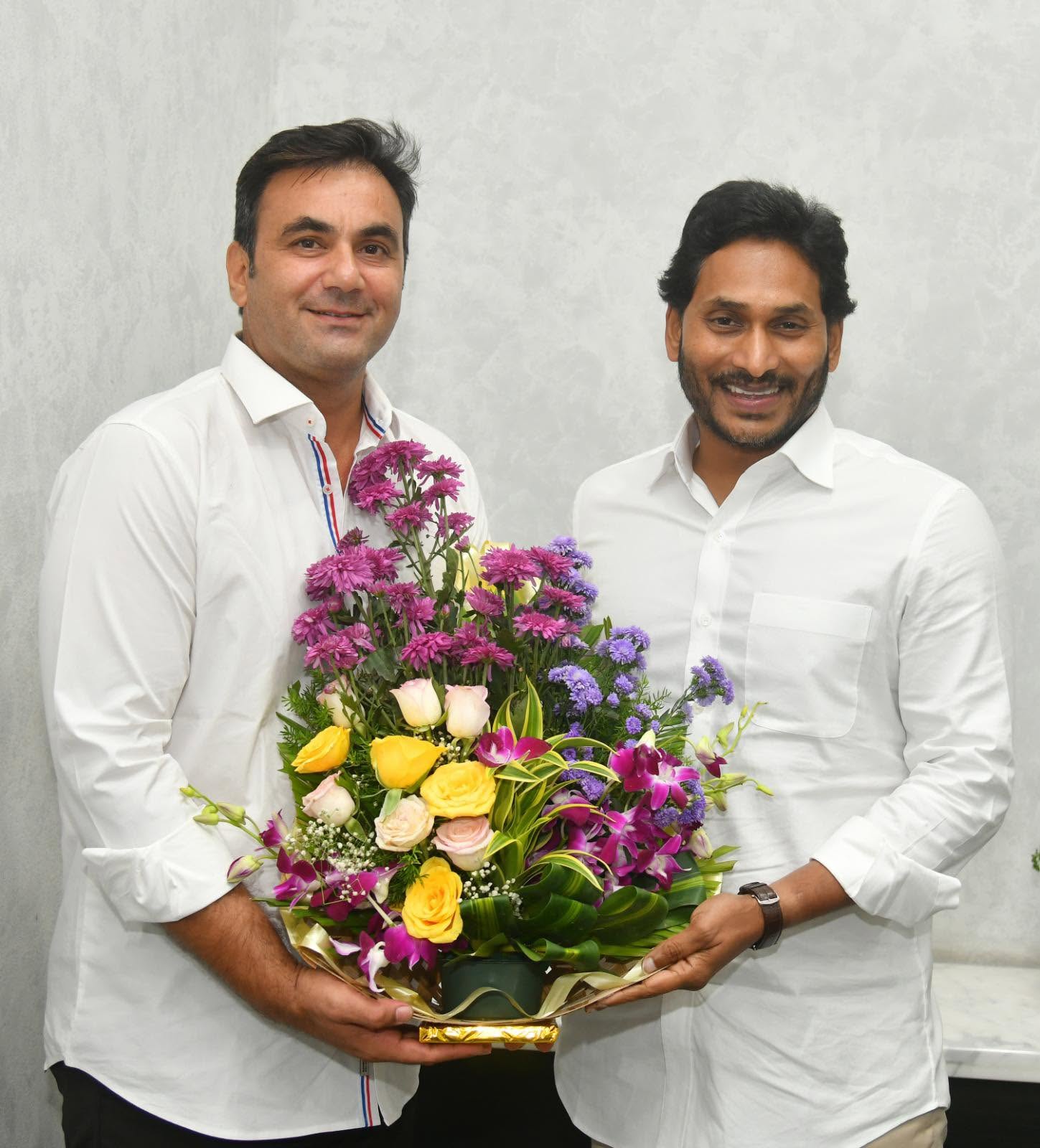 Ahmed Ali Khan presenting a bouquet to Y.S. Jagan Mohan Reddy, President of the YSR Congress Party